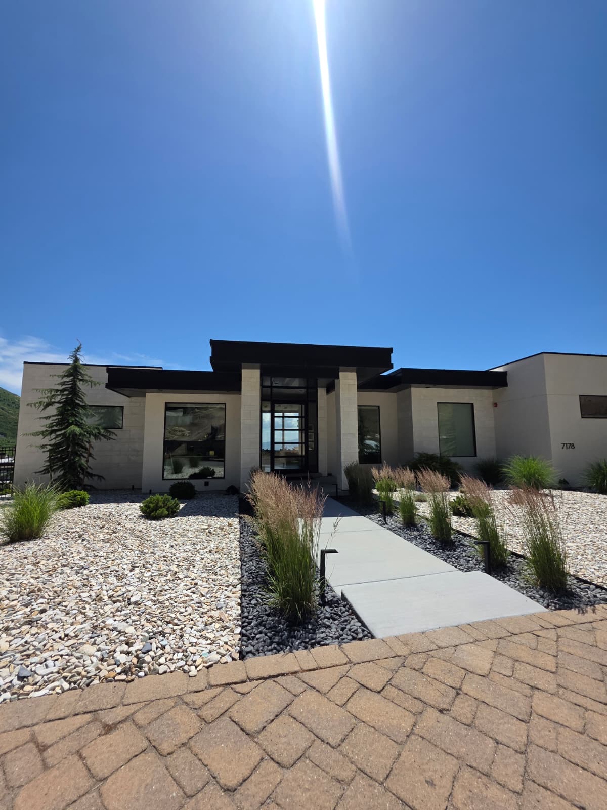 Modern white home with a newly installed architectural shingle roof in Utah